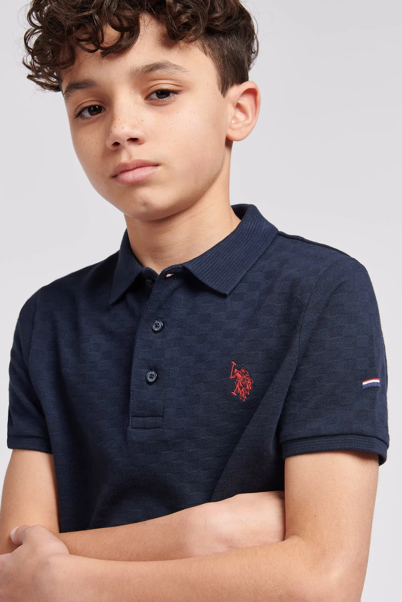 Boys Check Texture Polo Shirt in Dark Sapphire Navy / Haute Red DHM